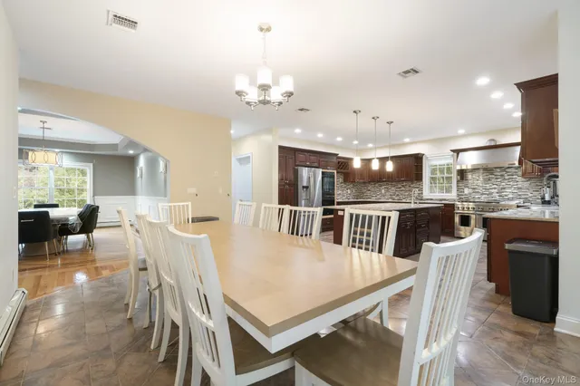 a large kitchen with a table and chairs