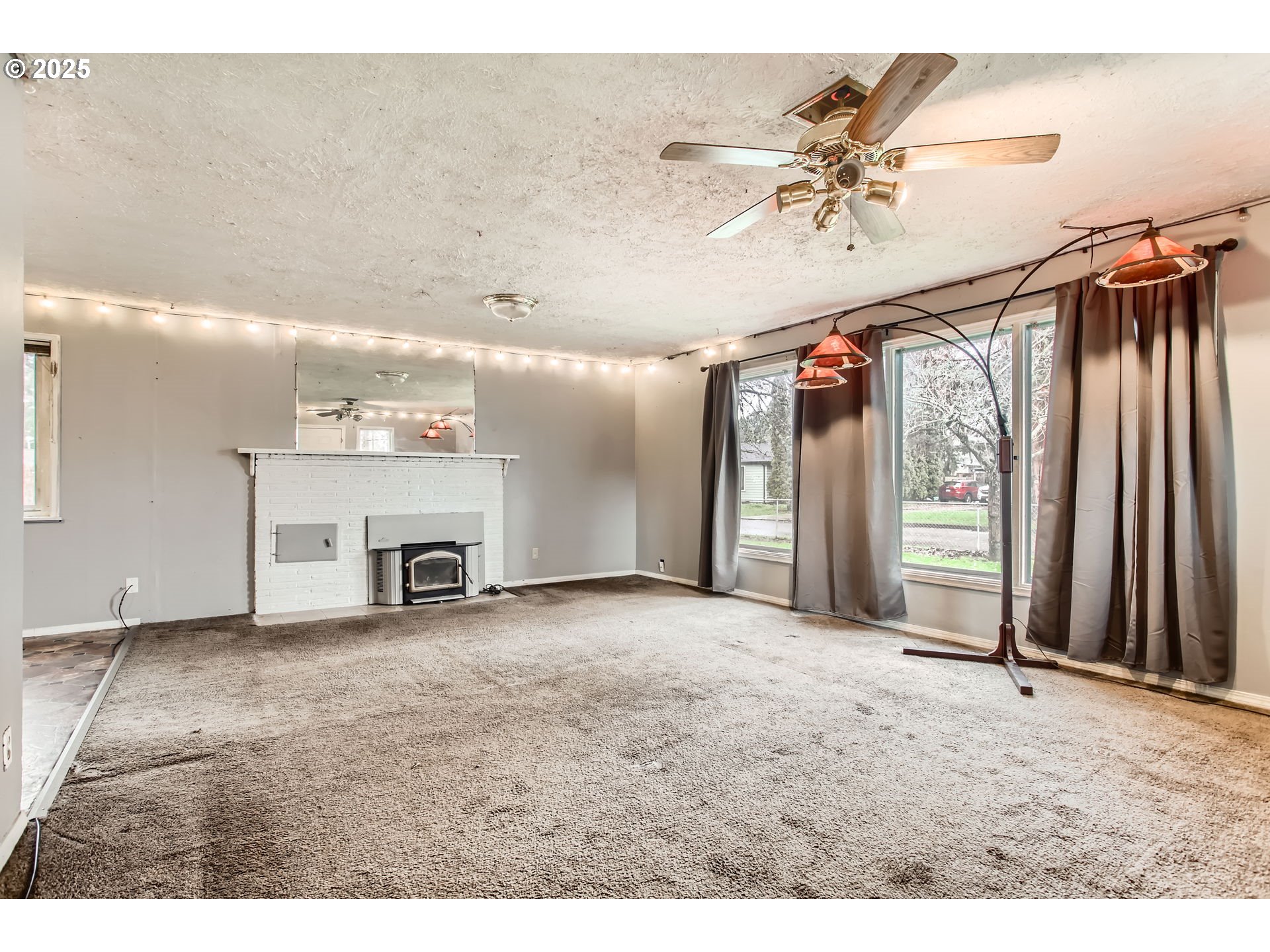 245 Southwest 133rd Avenue Beaverton, OR 97005 - Photo 2 of 12 a view of an empty room with a ceiling fan