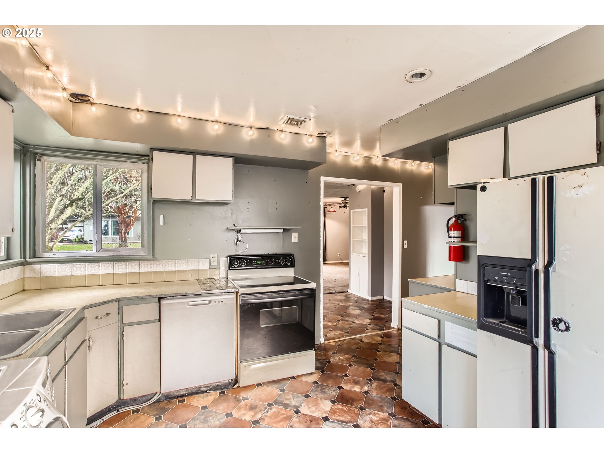 245 Southwest 133rd Avenue Beaverton, OR 97005 - Photo 5 of 12 a kitchen with stainless steel appliances a refrigerator sink and cabinets