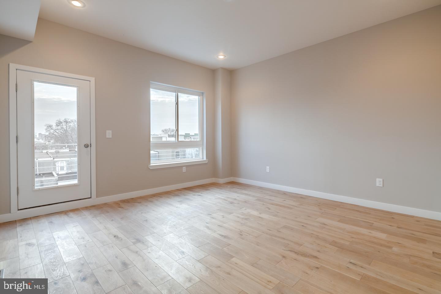 1636 Ridge Avenue, Unit PH Philadelphia, PA 19130 - Photo 13 of 16 a view of an empty room with wooden floor and a window