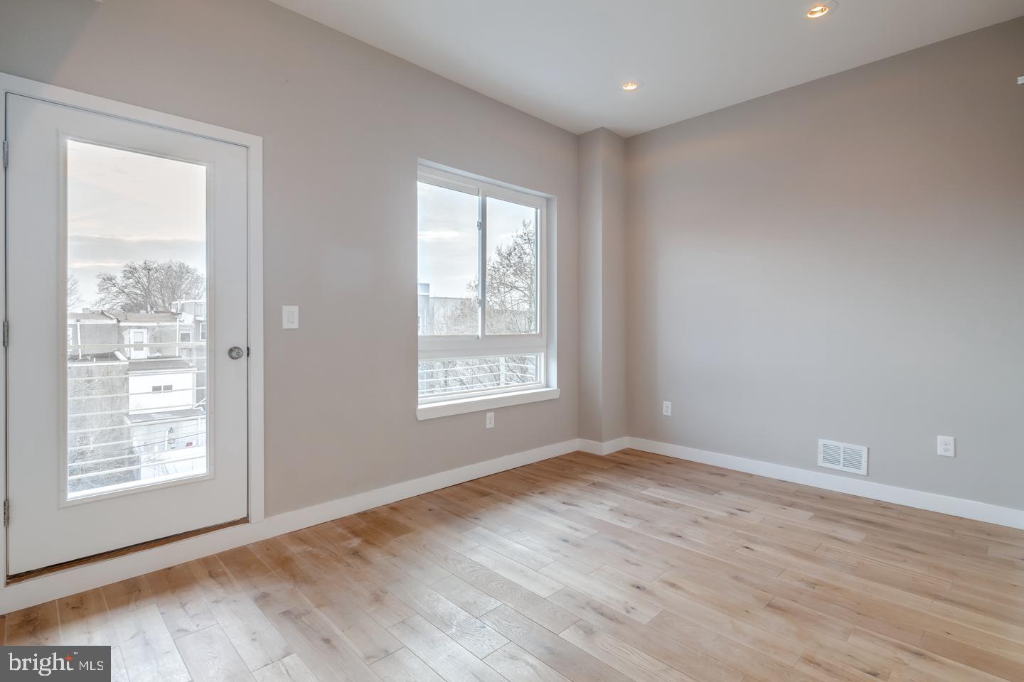 1636 Ridge Avenue, Unit PH Philadelphia, PA 19130 - Photo 14 of 16 a view of an empty room with wooden floor and a window