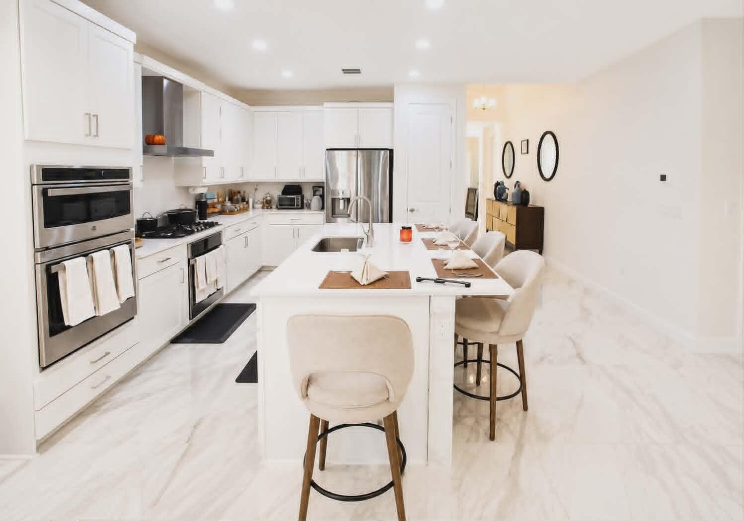 19179 Rolling Acrs Road Loxahatchee, FL 33470 - Photo 15 of 38 a kitchen with stainless steel appliances kitchen island granite countertop a stove a sink and a microwave
