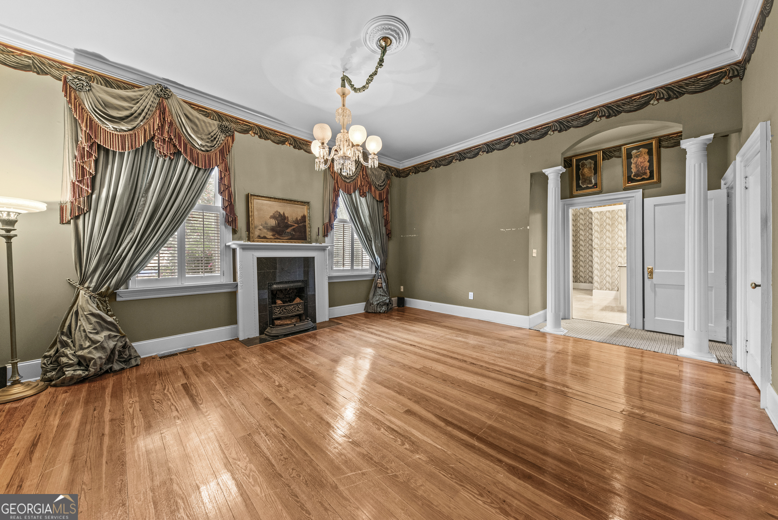 1155 Floyd Street Northeast Covington, GA 30014 - Photo 28 of 65 a view of a livingroom with wooden floor and a ceiling fan