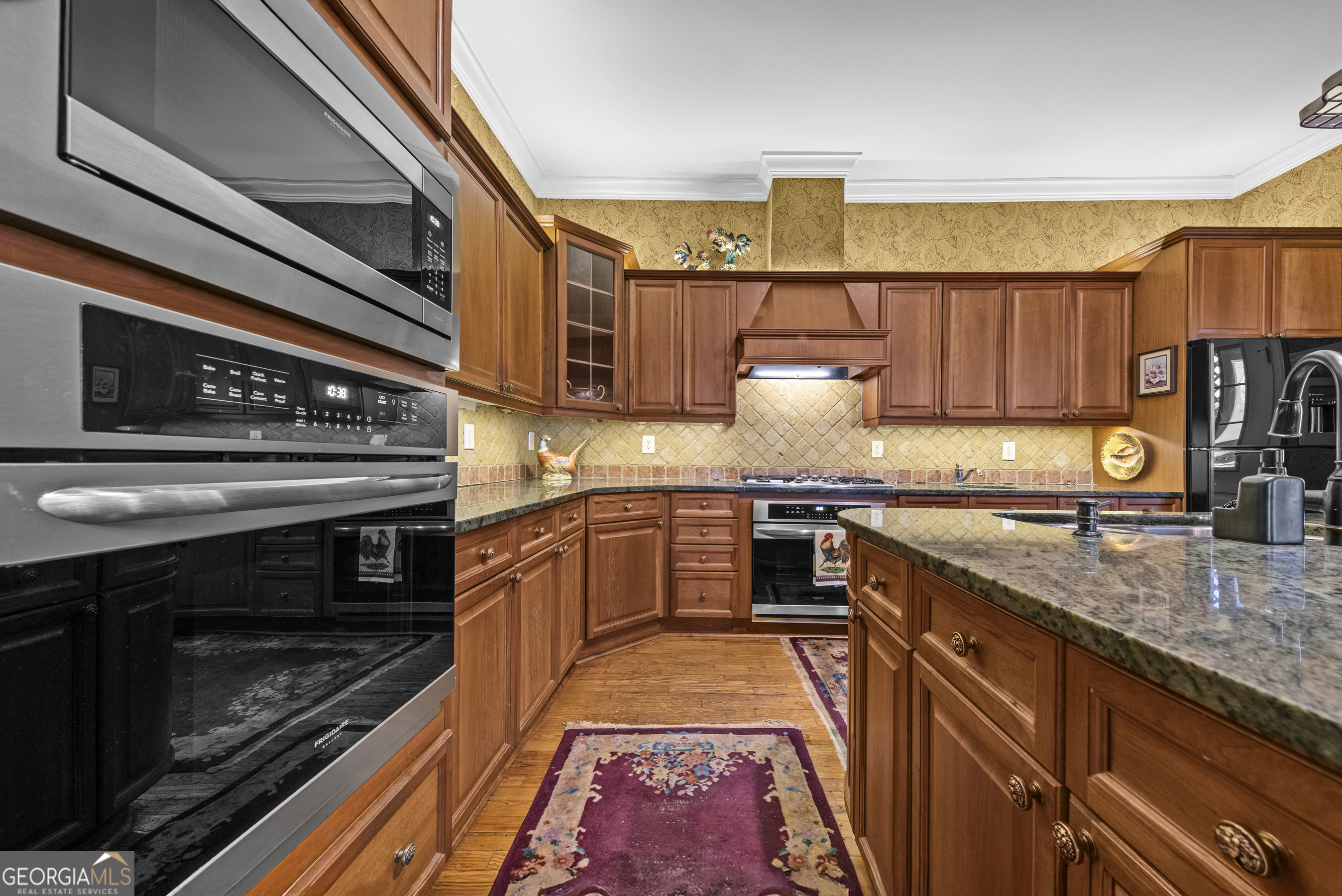 1155 Floyd Street Northeast Covington, GA 30014 - Photo 31 of 65 a kitchen with stainless steel appliances granite countertop a stove a sink and a microwave