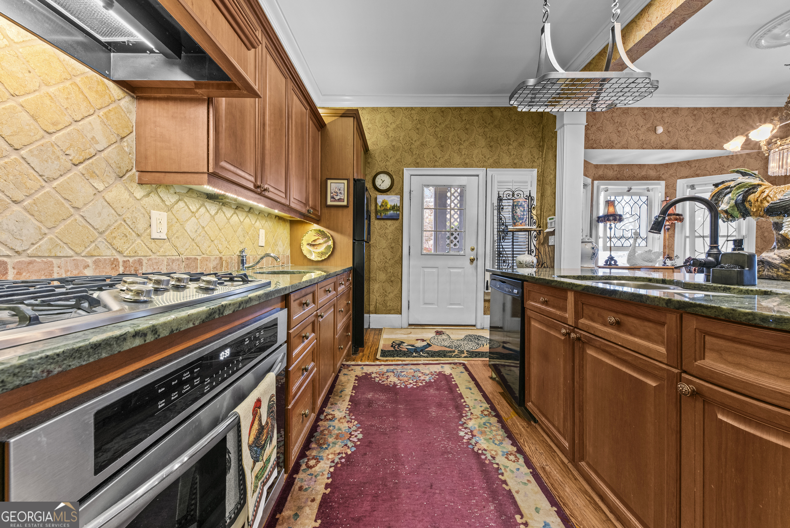 1155 Floyd Street Northeast Covington, GA 30014 - Photo 34 of 65 a kitchen with stainless steel appliances granite countertop a stove and a sink