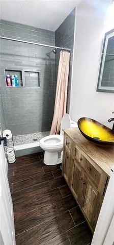 a bathroom with a sink mirror vanity and toilet