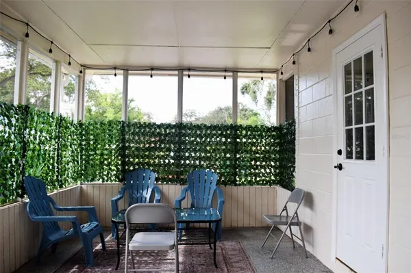 a view of a chairs and table in the balcony