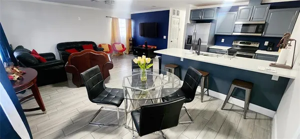 a dining room with furniture and wooden floor