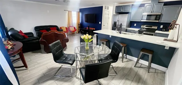 a dining room with furniture and wooden floor
