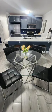 a kitchen with a sink a stove and chairs