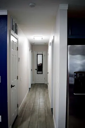 a view of a hallway with wooden floor