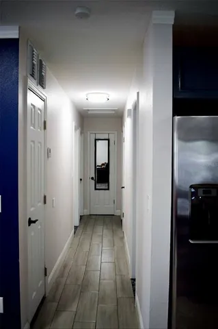 a view of a hallway with wooden floor