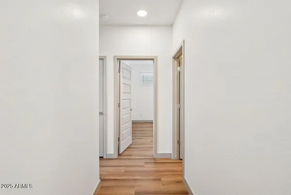 a view of a hallway with wooden floor and staircase