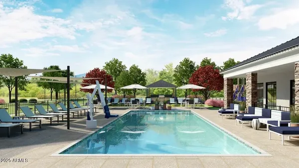 a view of a swimming pool with lawn chairs