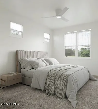 a bed sitting in a bedroom next to a window