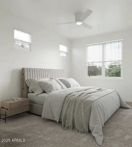 a living room with large couches chandelier and a large window