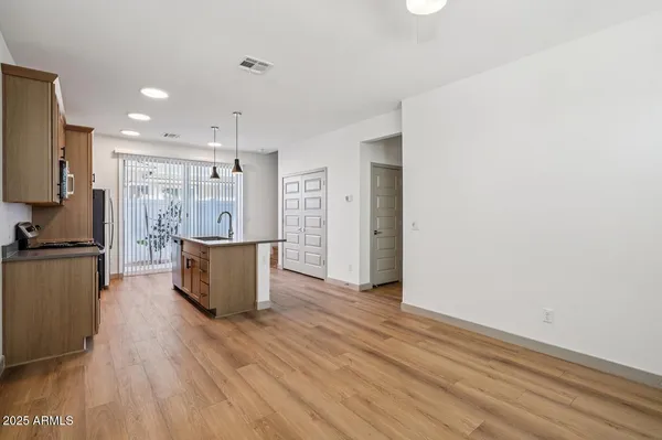 a room with wooden floor and large window