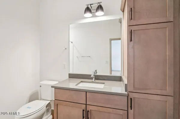 a bathroom with a sink toilet and mirror