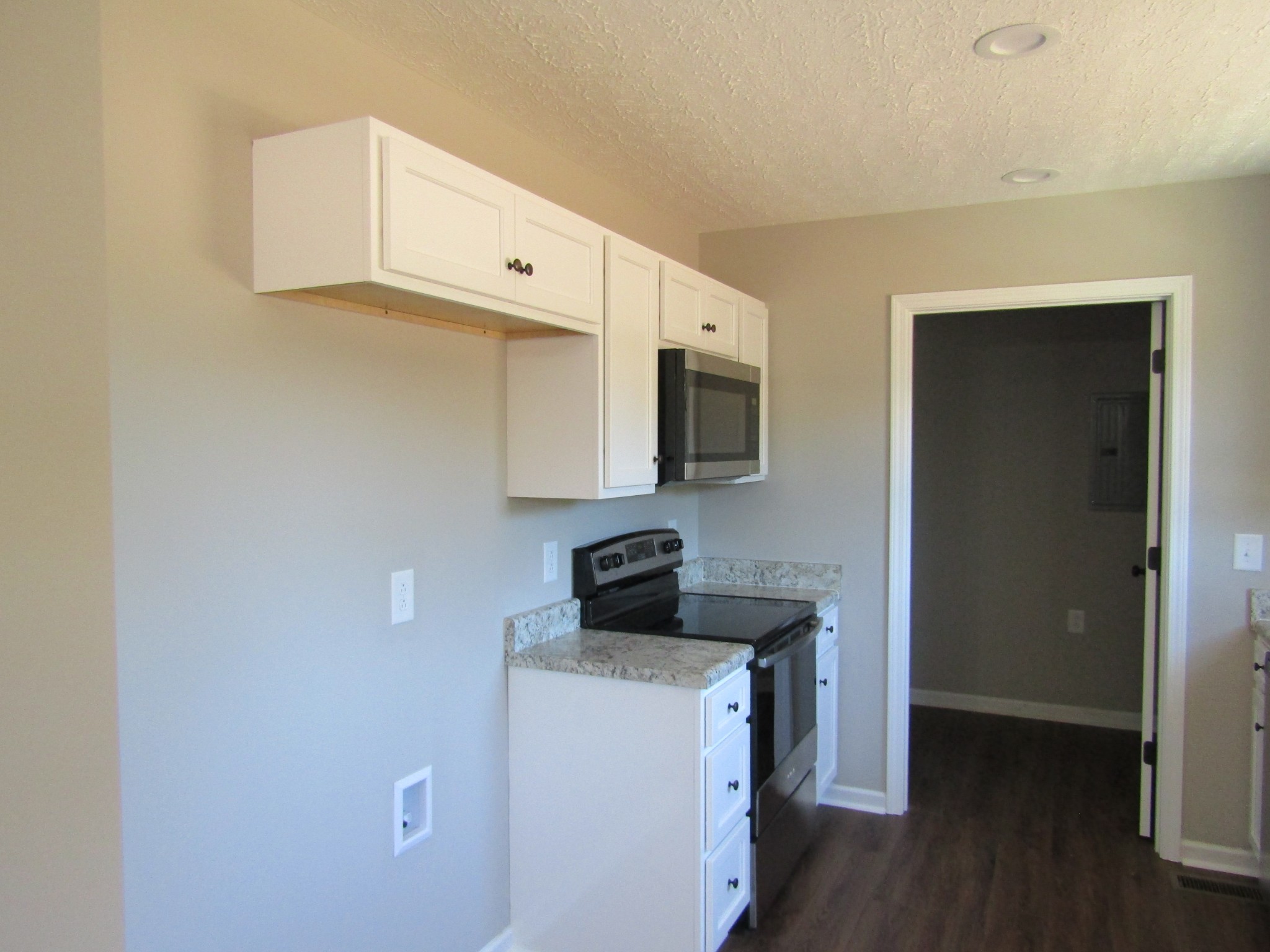 460 Crescent Factory Road Lawrenceburg, TN 38464 - Photo 6 of 13 a kitchen with stainless steel appliances white cabinets and a stove top oven