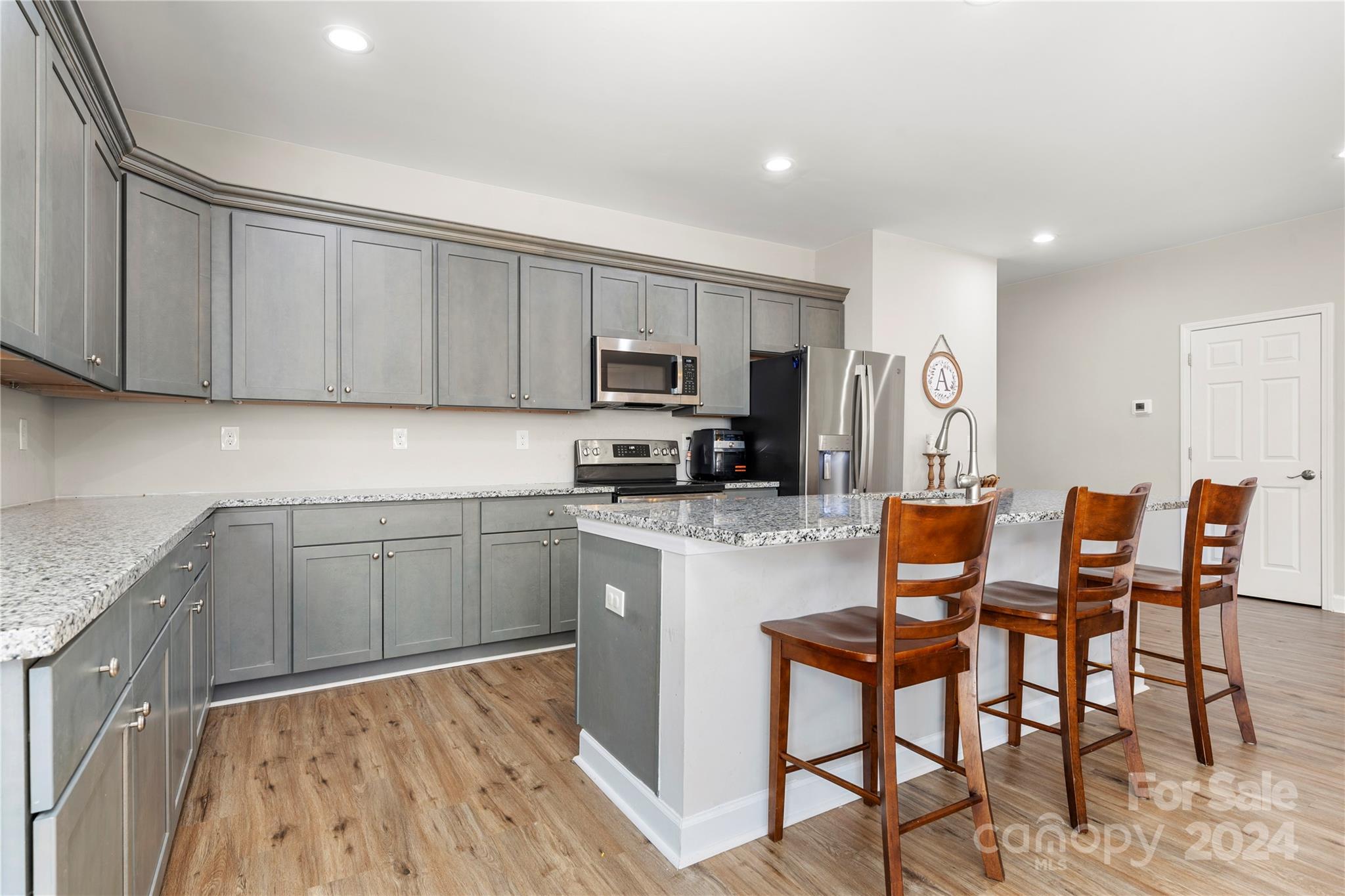218 Rambler Lane Blacksburg, SC 29702 - Photo 11 of 42 a kitchen with stainless steel appliances granite countertop a stove top oven a sink dishwasher and a microwave oven with wooden cabinets