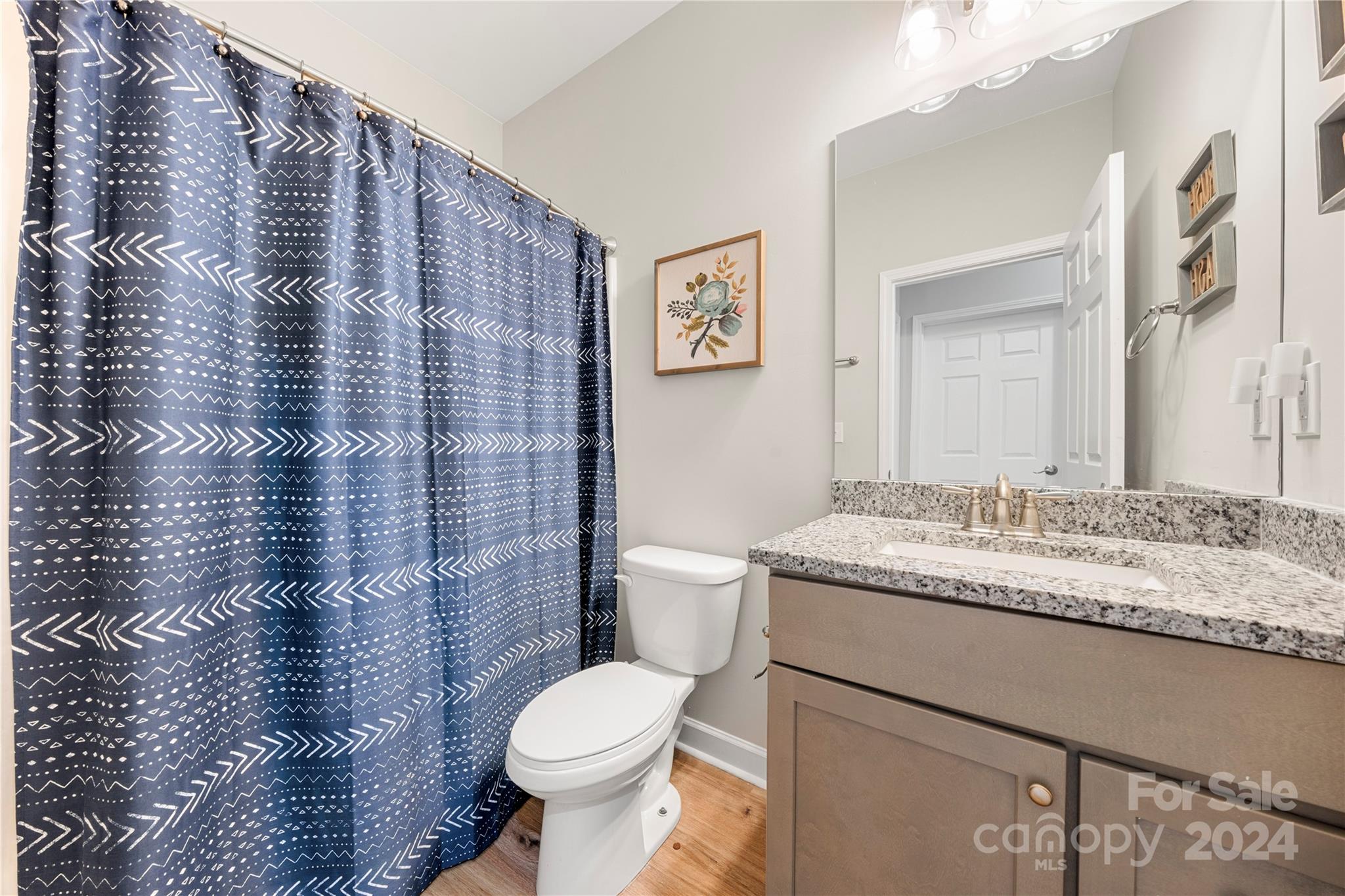 218 Rambler Lane Blacksburg, SC 29702 - Photo 23 of 42 a bathroom with a granite countertop toilet sink and mirror