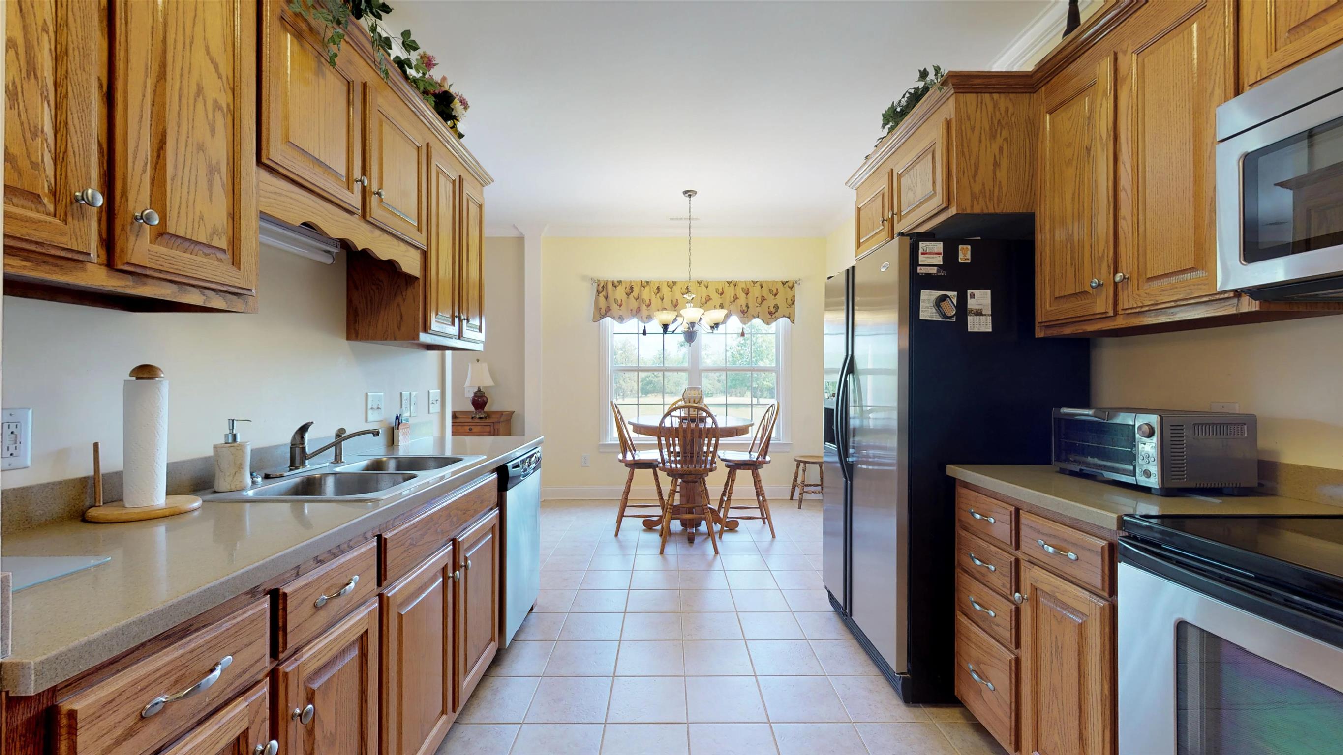 9502 Link Road Christiana, TN 37037 - Photo 14 of 25 a kitchen with stainless steel appliances granite countertop wooden cabinets a sink dishwasher a stove and a refrigerator with wooden floor