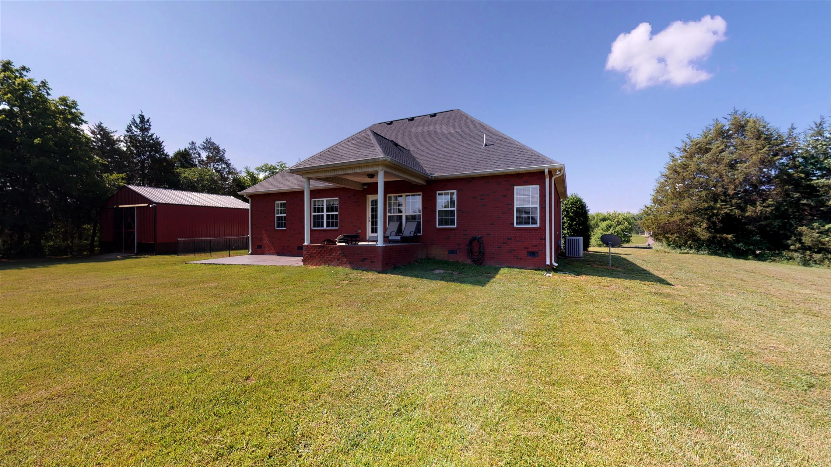 9502 Link Road Christiana, TN 37037 - Photo 22 of 25 a front view of a house with a yard
