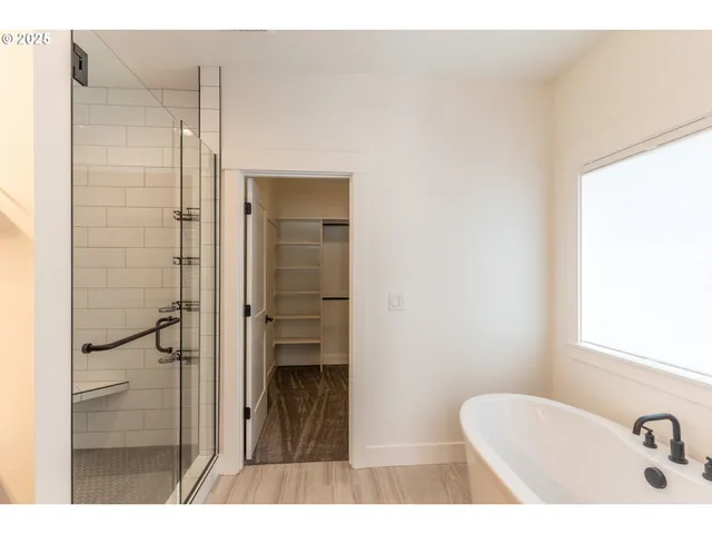 a bathroom with a sink a toilet a mirror and shower