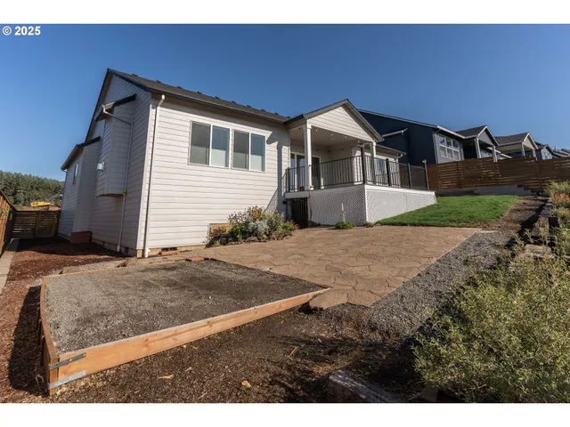 an aerial view of a house with swimming pool garden and patio
