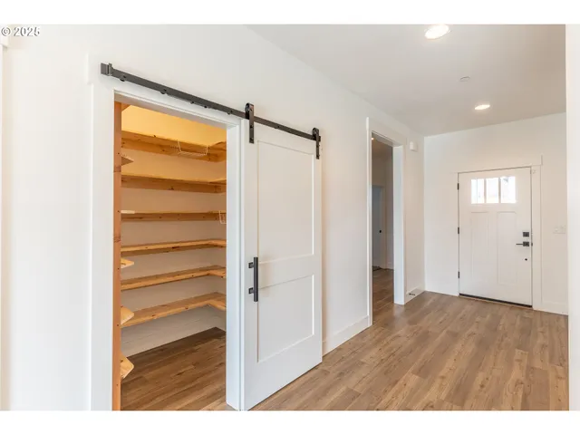 a kitchen with kitchen island a sink stainless steel appliances and wooden floor