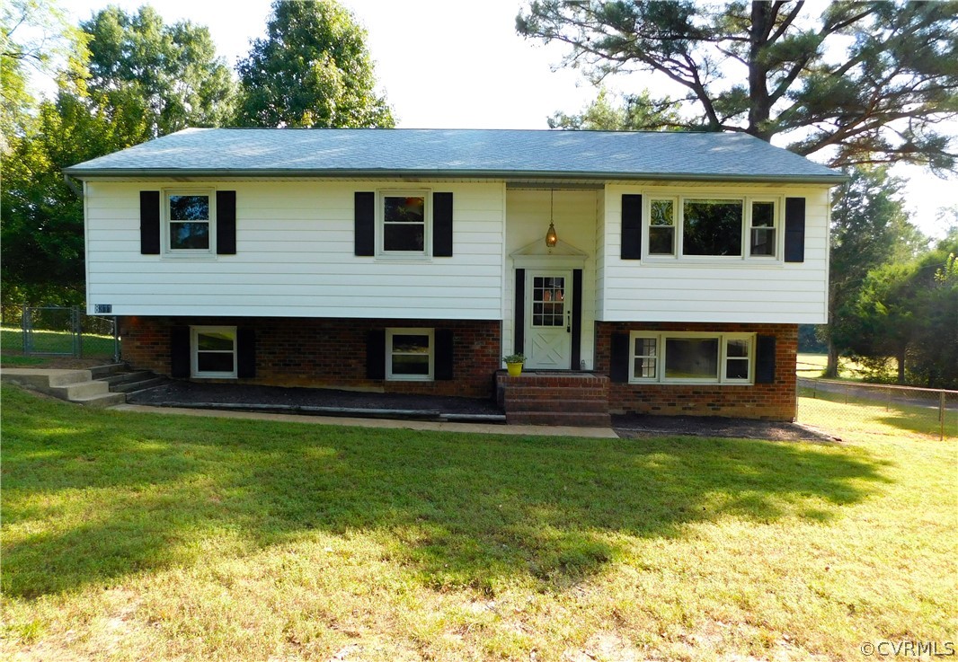 8311 Hopkins Road North Chesterfield, VA 23237 - Photo 1 of 39 a front view of a house with a garden
