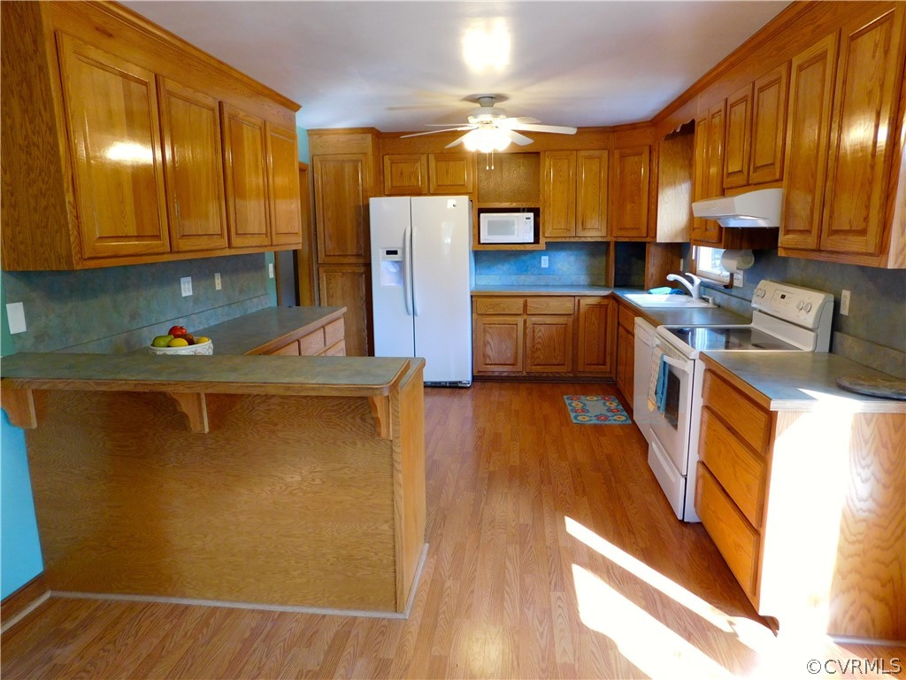 8311 Hopkins Road North Chesterfield, VA 23237 - Photo 12 of 39 a kitchen with a sink a refrigerator and cabinets