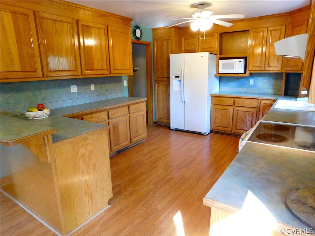 8311 Hopkins Road North Chesterfield, VA 23237 - Photo 13 of 39 a kitchen with stainless steel appliances wooden floors and a refrigerator