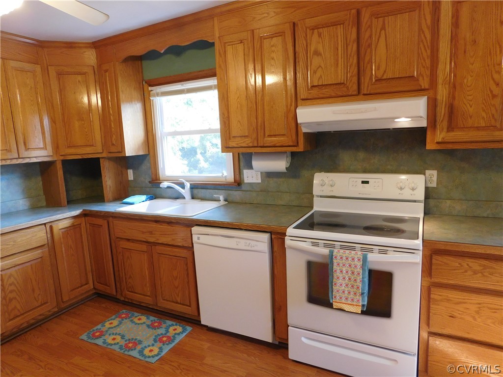 8311 Hopkins Road North Chesterfield, VA 23237 - Photo 14 of 39 a kitchen with granite countertop cabinets stainless steel appliances a sink and wooden floor
