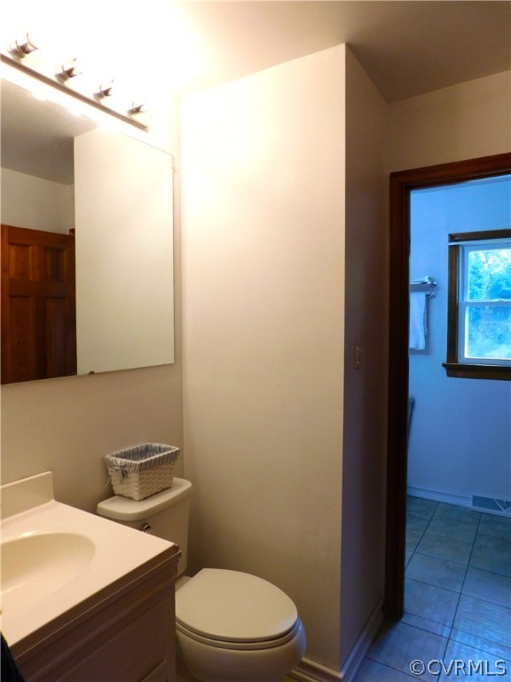 8311 Hopkins Road North Chesterfield, VA 23237 - Photo 16 of 39 a bathroom with a sink a toilet and mirror