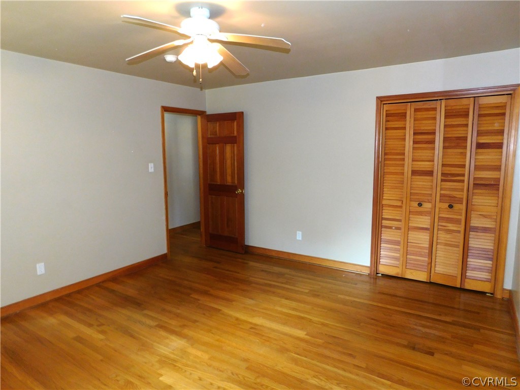 8311 Hopkins Road North Chesterfield, VA 23237 - Photo 18 of 39 an empty room with wooden floor closet and windows