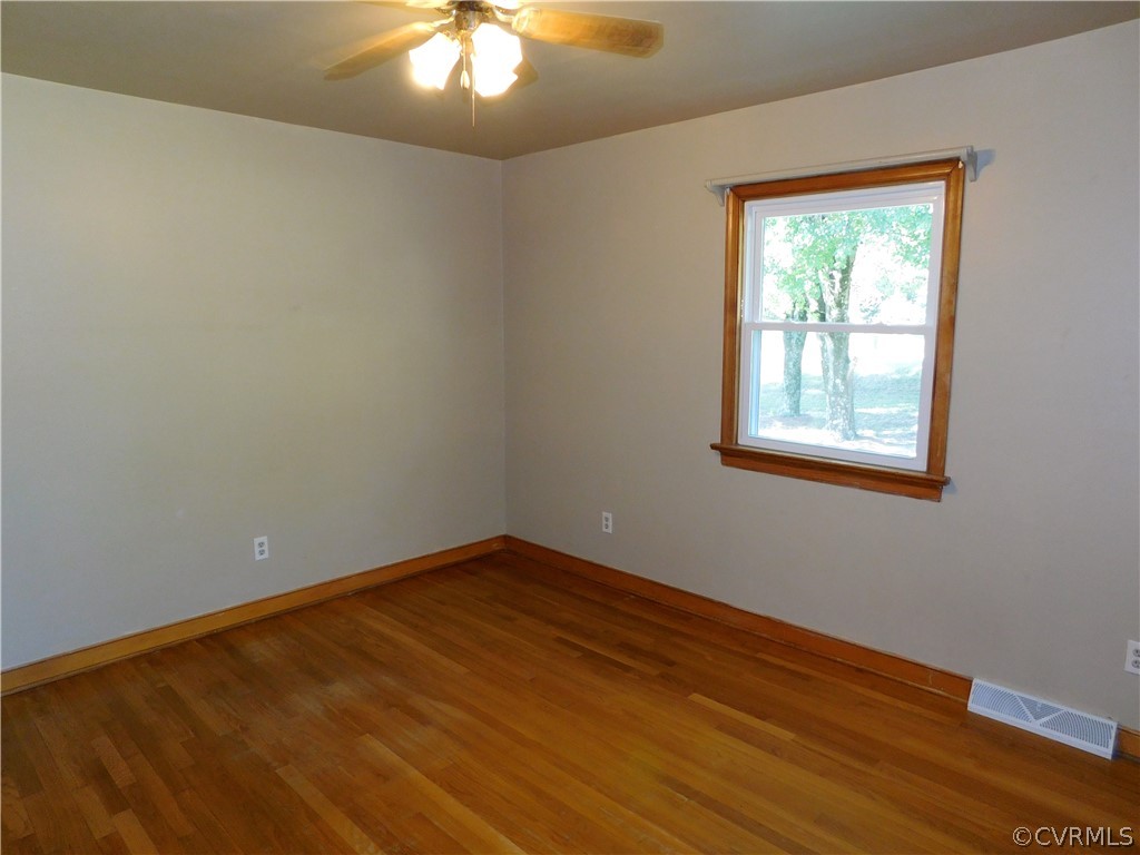 8311 Hopkins Road North Chesterfield, VA 23237 - Photo 20 of 39 a view of an empty room with wooden floor and a window