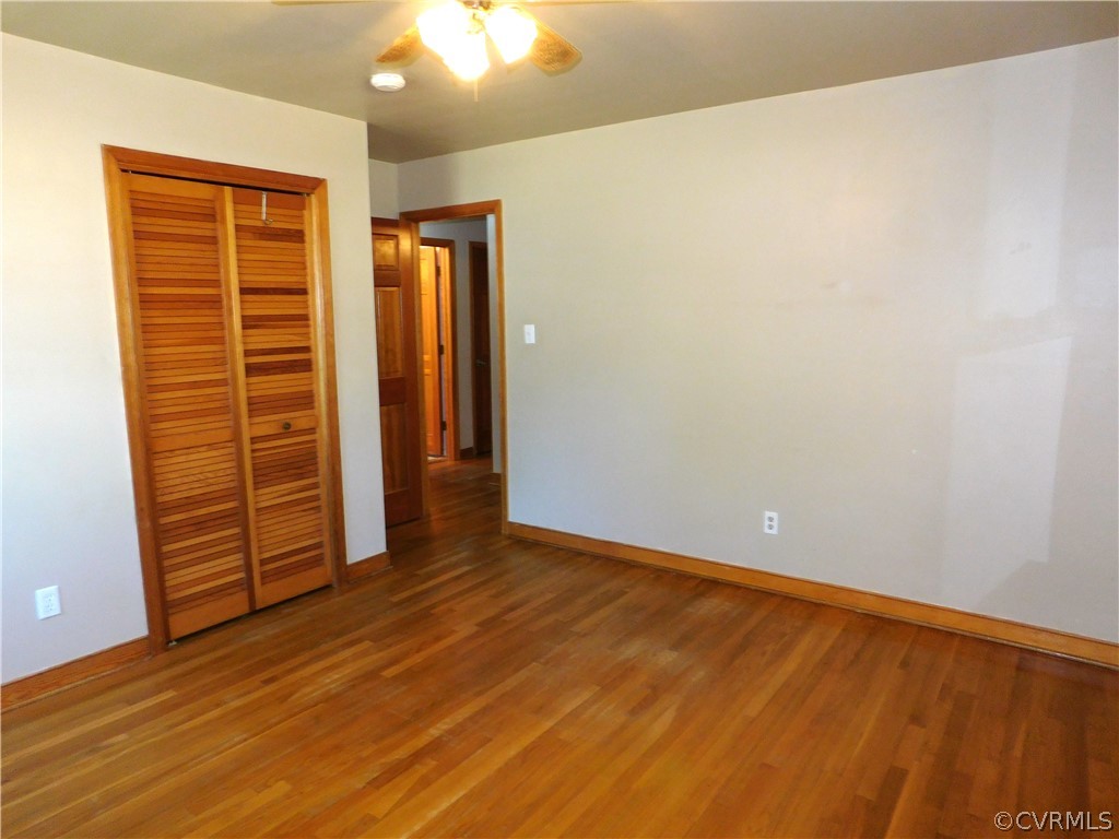 8311 Hopkins Road North Chesterfield, VA 23237 - Photo 23 of 39 an empty room with wooden floor closet and windows