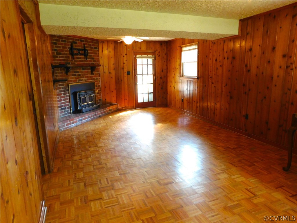 8311 Hopkins Road North Chesterfield, VA 23237 - Photo 25 of 39 wooden floor in an empty room with a fireplace