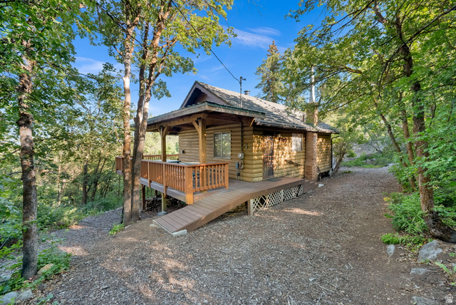 1234 Maple Lane, Unit 123 Midway, UT 84049 - Photo 2 of 19 Rustic cabin exterior featuring wood log look construction, a covered front porch with railings, and a wood ramp entry