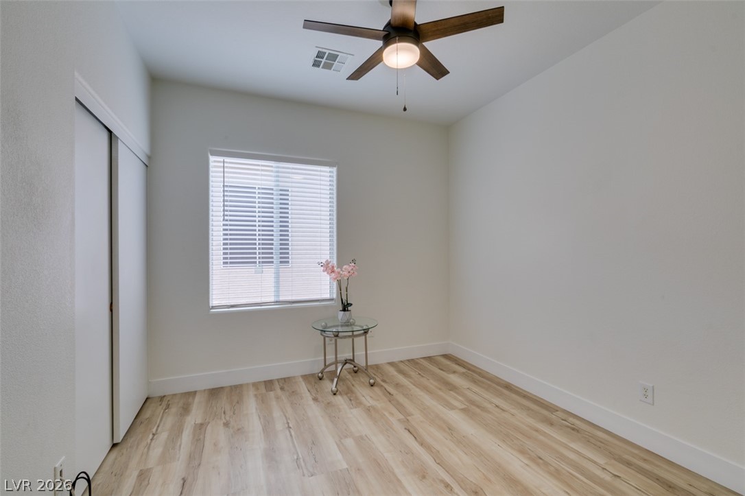 10959 Pumpkin Ridge Avenue Las Vegas, NV 89135 - Photo 20 of 51 Well-lit master bedroom with durable LVP flooring and a modern ceiling fan for comfort.