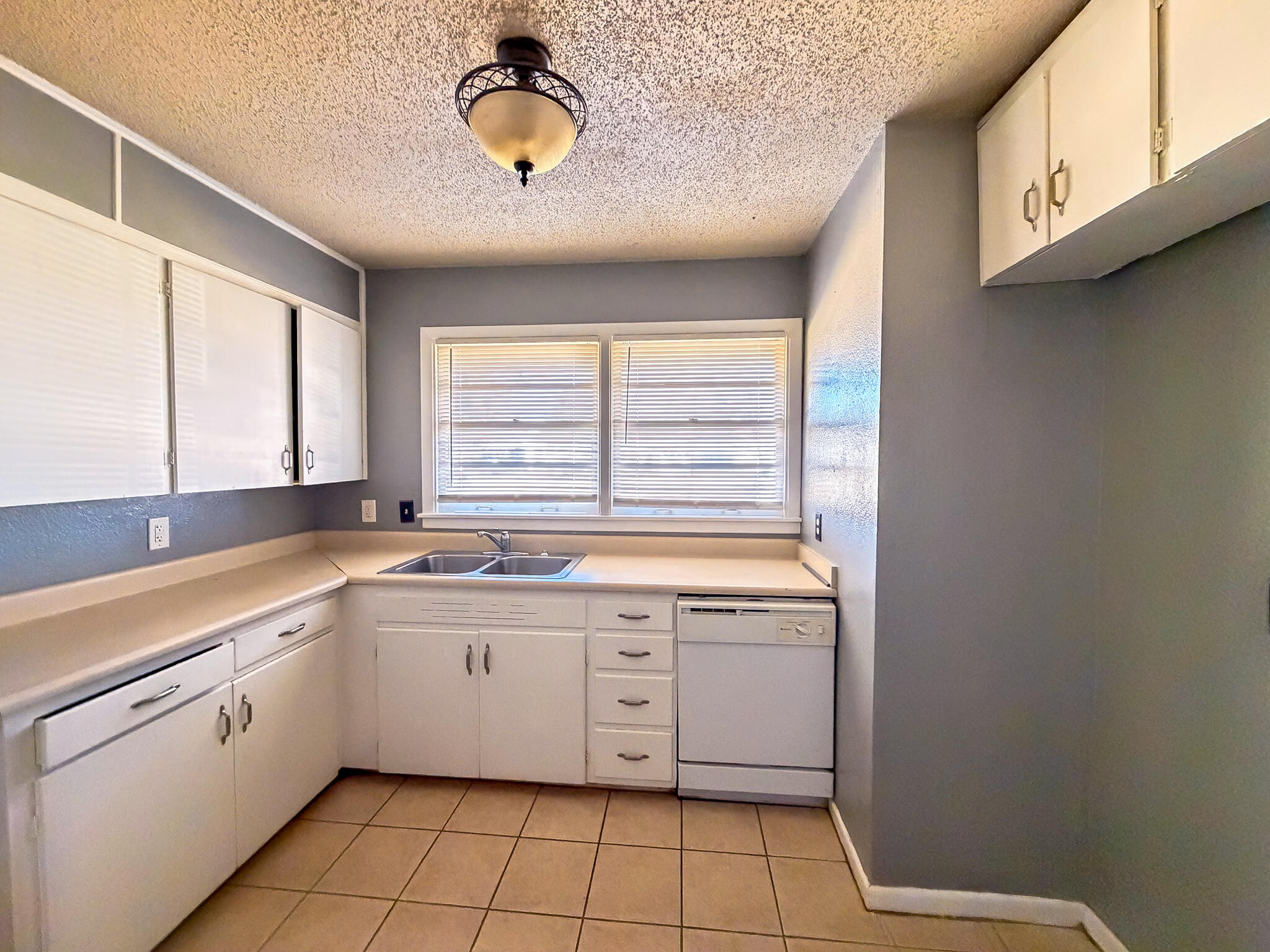 2805 53rd Street Lubbock, TX 79413 - Photo 11 of 13 a kitchen with a sink cabinets and window