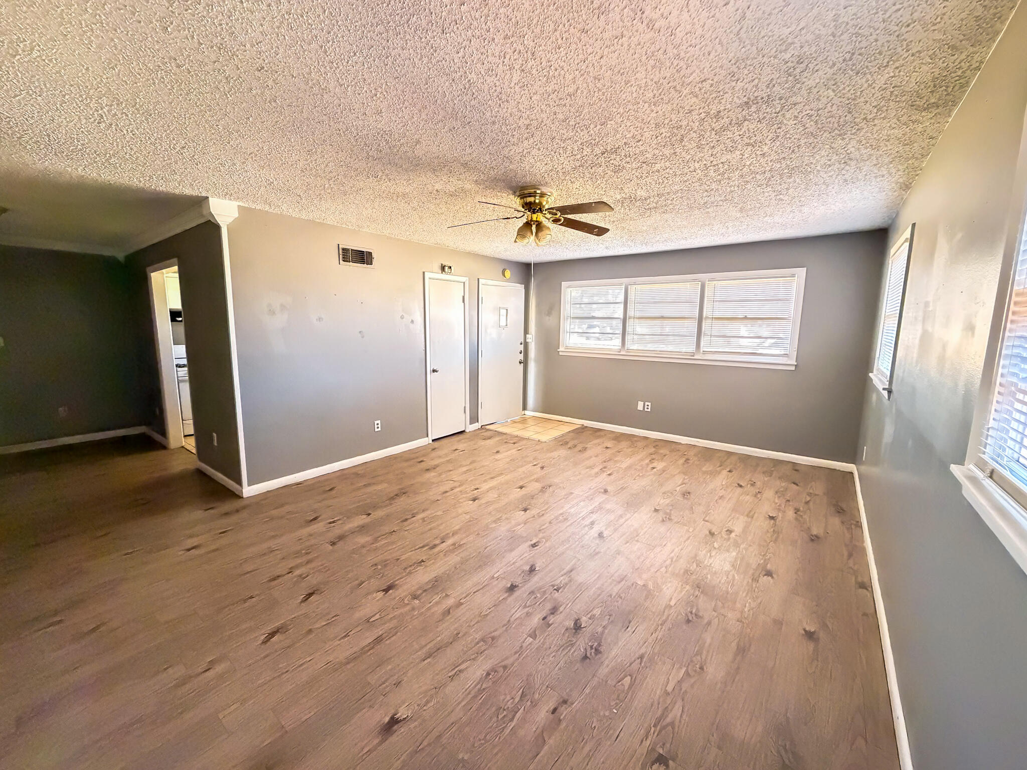 2805 53rd Street Lubbock, TX 79413 - Photo 12 of 13 an empty room with wooden floor and windows