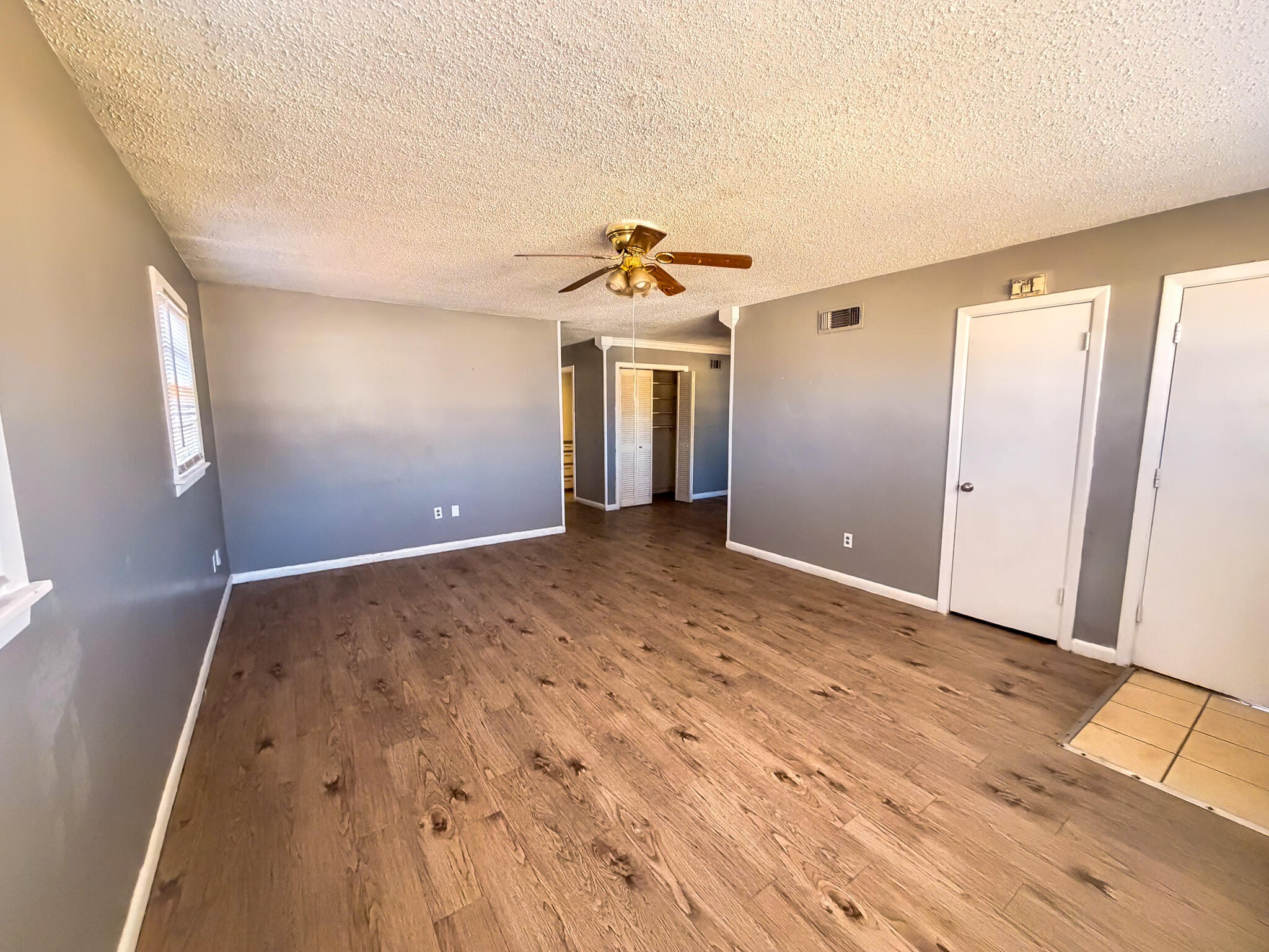 2805 53rd Street Lubbock, TX 79413 - Photo 13 of 13 wooden floor in an empty room with a window