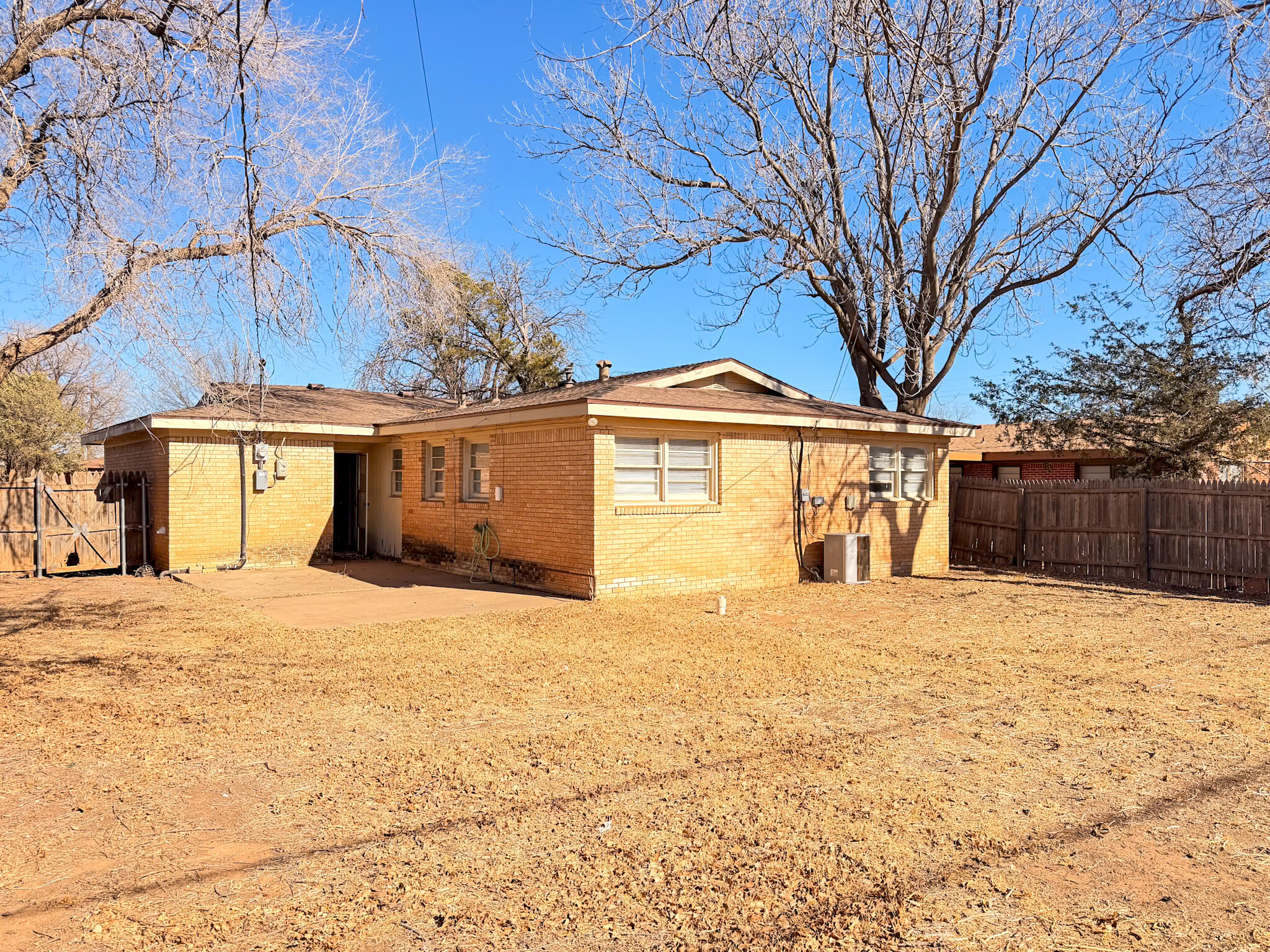 2805 53rd Street Lubbock, TX 79413 - Photo 2 of 13 a front view of a house with a yard covered in snow