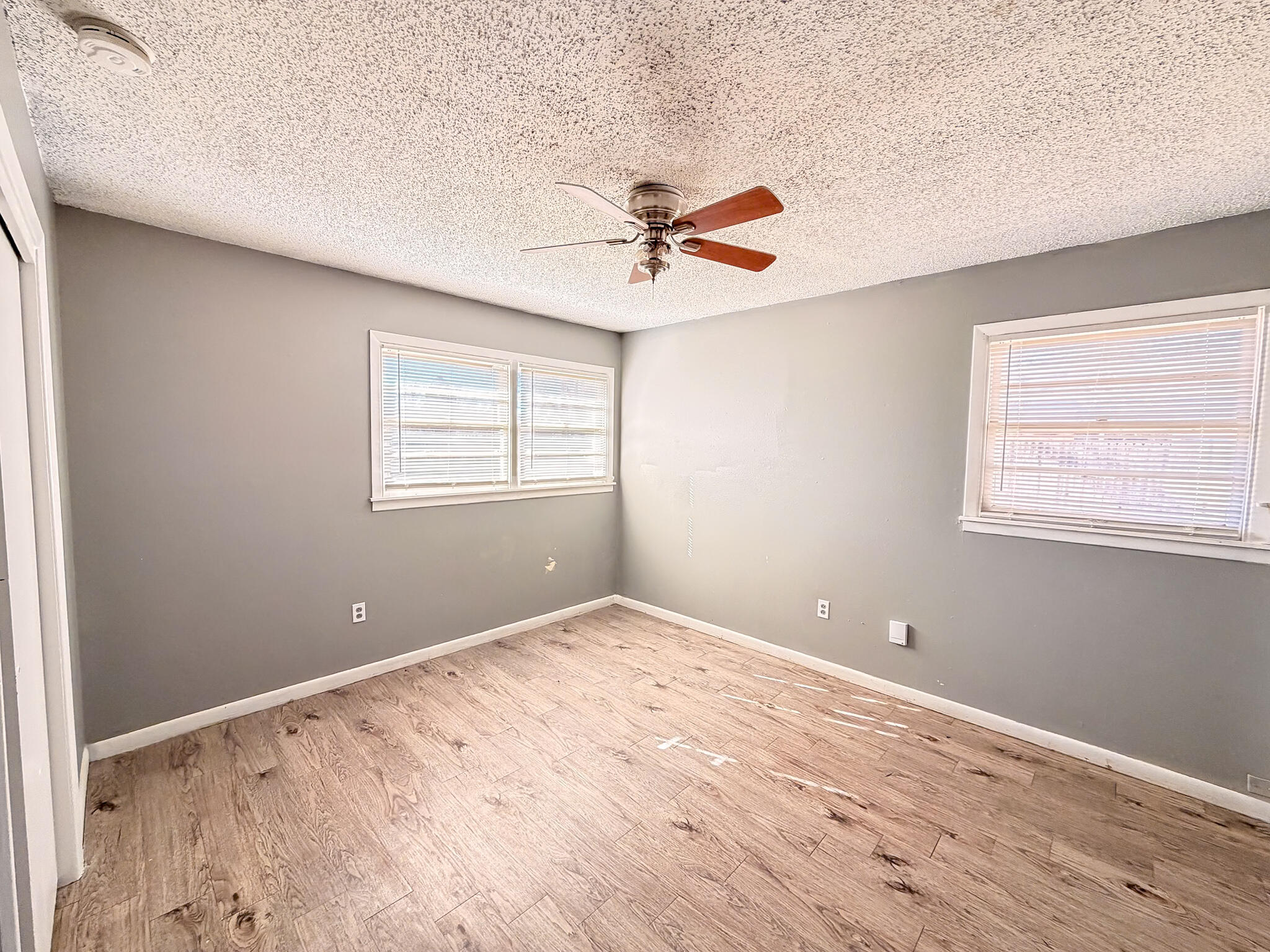 2805 53rd Street Lubbock, TX 79413 - Photo 5 of 13 an empty room with windows and fan