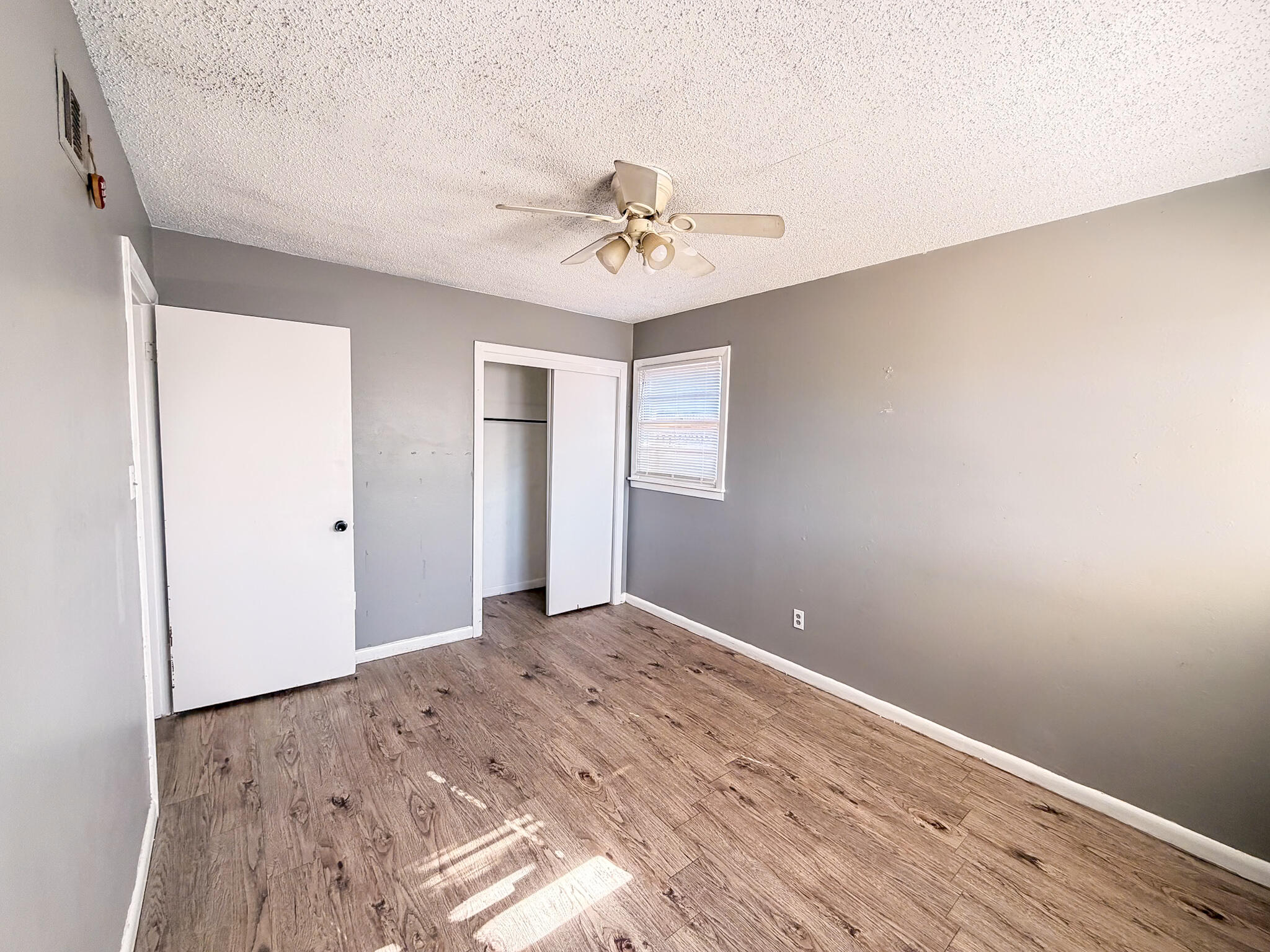 2805 53rd Street Lubbock, TX 79413 - Photo 6 of 13 wooden floor in an empty room with a window
