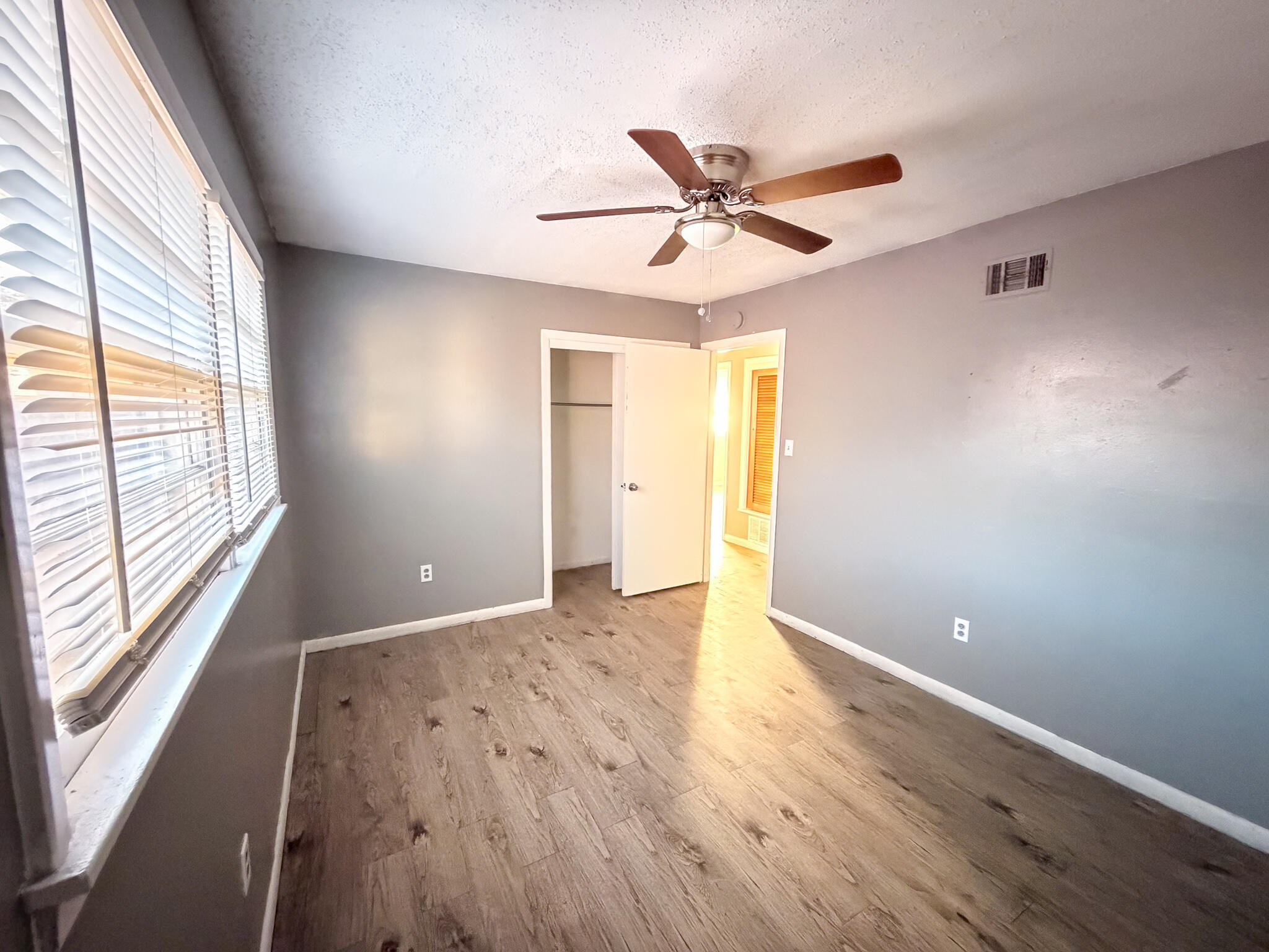 2805 53rd Street Lubbock, TX 79413 - Photo 8 of 13 a view of an empty room with window and wooden floor