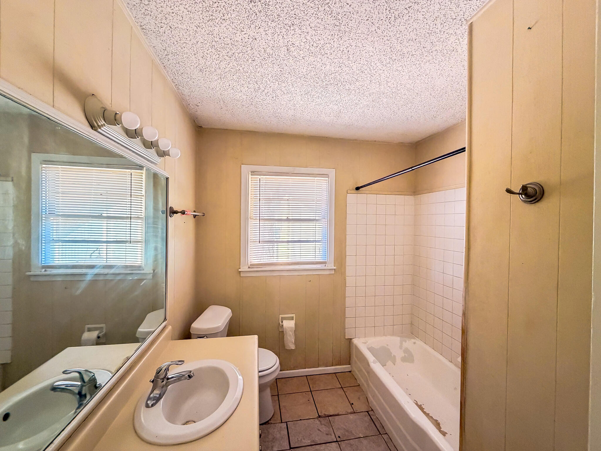 2805 53rd Street Lubbock, TX 79413 - Photo 9 of 13 a bathroom with a sink a toilet and shower