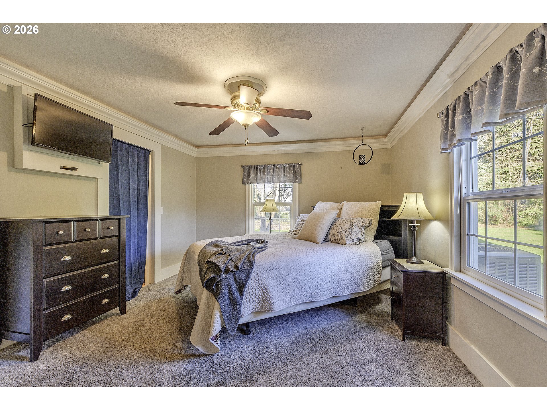 58059 Shadley Lane Warren, OR 97053 - Photo 17 of 33 a bedroom with a bed and a chandelier